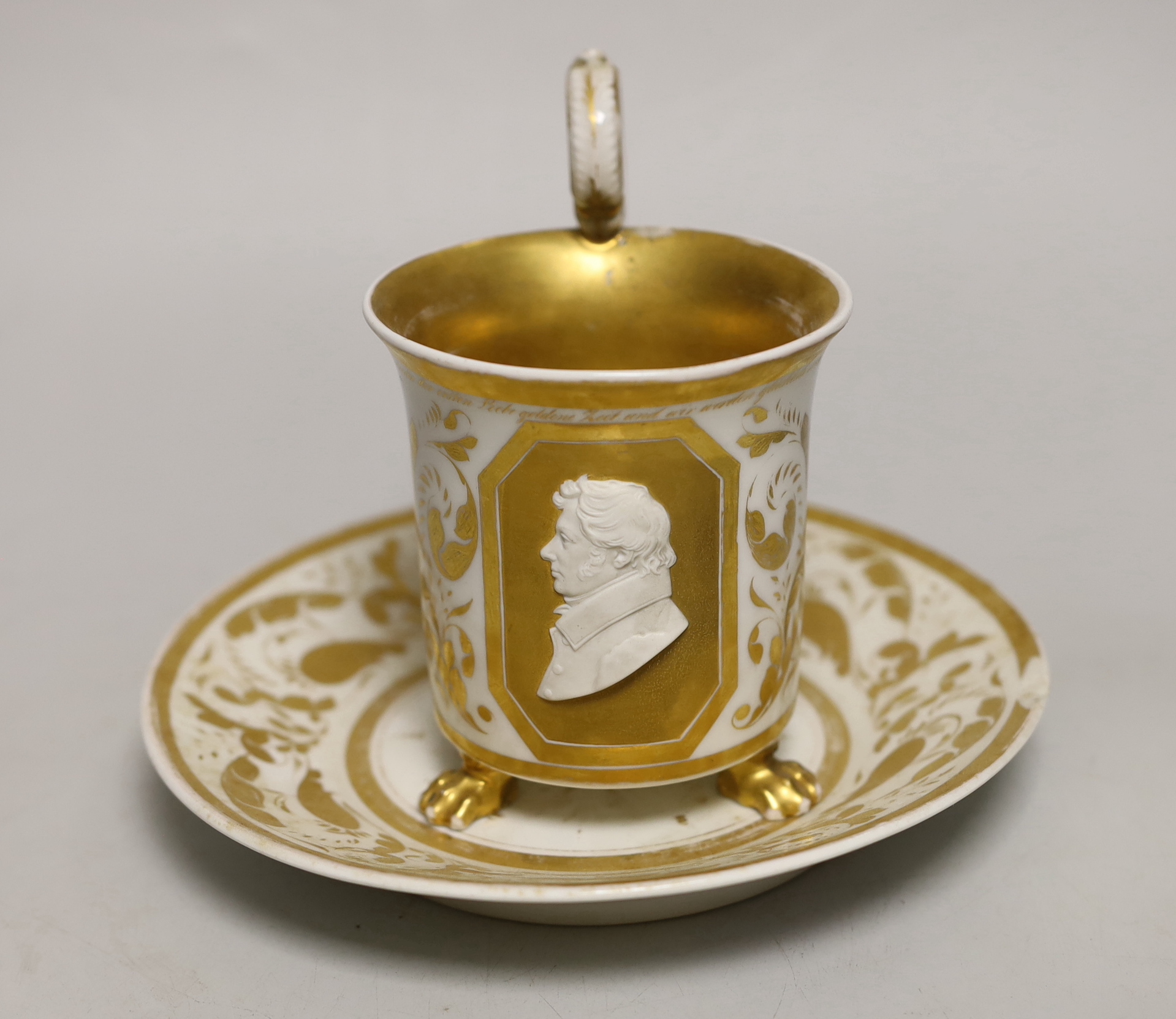 A Berlin porcelain cameo portrait cup and saucer, first half 19th century, cup 13cm to top of handle